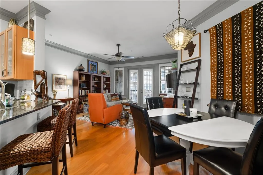 Dining room featuring crown molding, light wood-style flooring, and ceiling fan