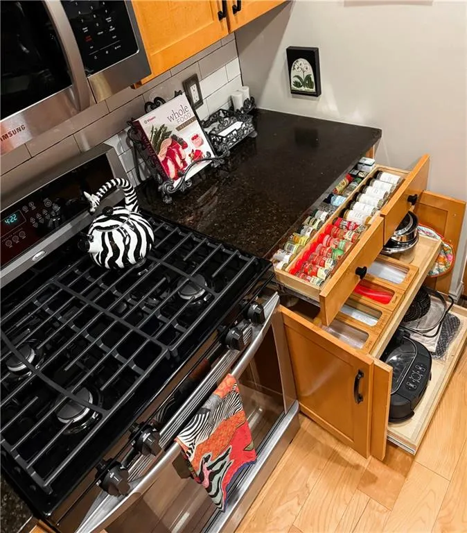 Kitchen view of gas stove and tasteful backsplash
