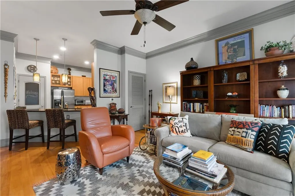 Living room with crown molding, ceiling fan, light wood-type flooring, and recessed lighting