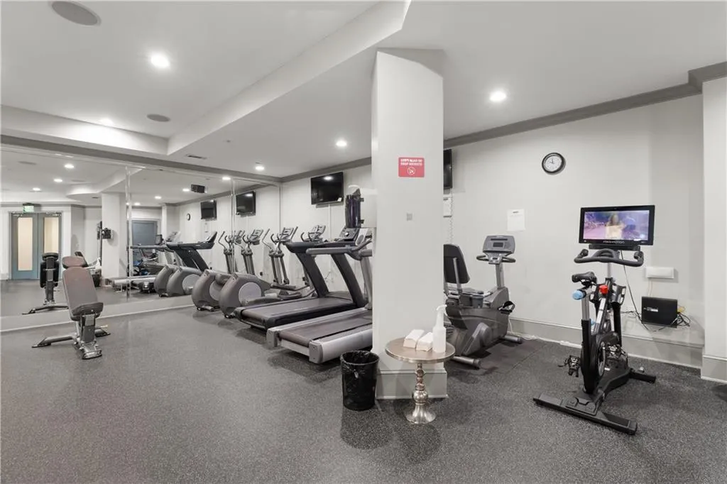 Workout area featuring crown molding and recessed lighting