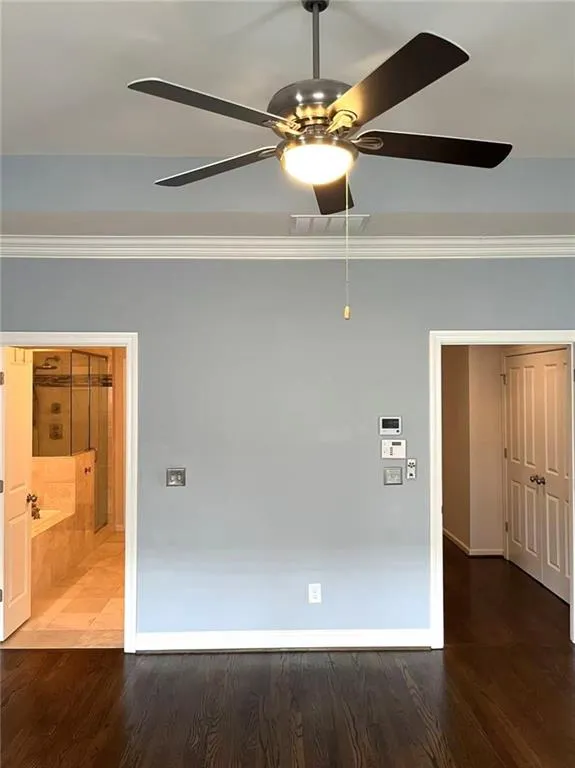 Living room with beam ceiling, coffered ceiling, wood finished floors, recessed lighting, and ceiling fan