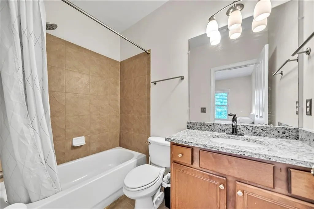 Full bathroom featuring shower / tub combo and vanity