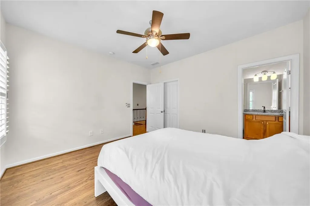 3rd level Bedroom with hardwood floors and ceiling fan and ensuite bathroom