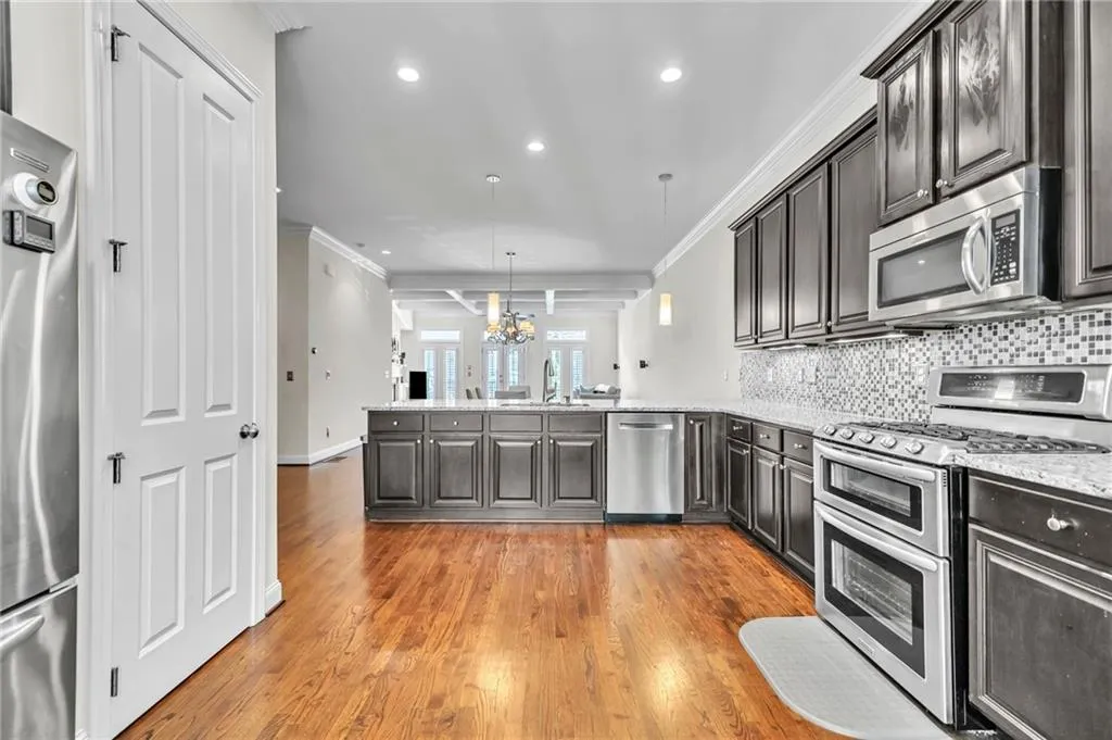 Stairway featuring ornamental molding, wood finished floors, and recessed lighting