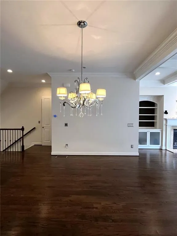 Kitchen featuring stainless steel appliances, crown molding, tasteful backsplash, light wood-style floors, and dark brown cabinetry