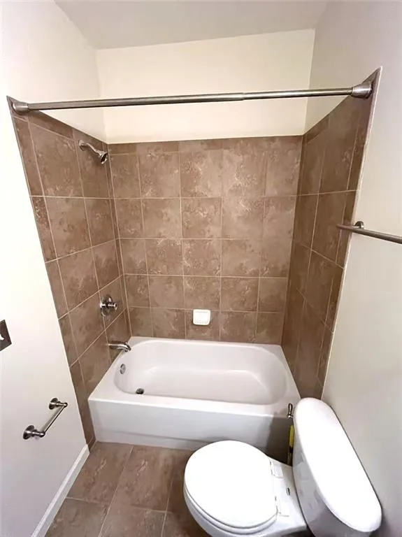 Bathroom with wood finished floors and a walk in closet