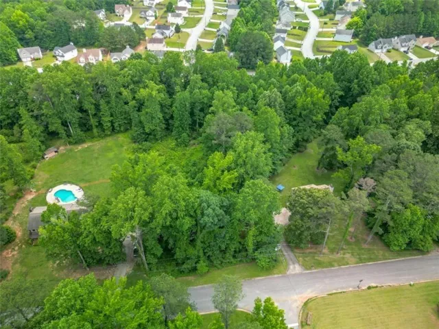 Aerial view of property's location with nearby suburban area