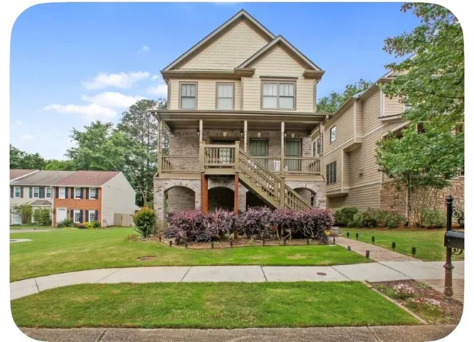 Multi-level exterior with brick and siding, featuring a covered front porch, an exterior staircase, and mature landscaping