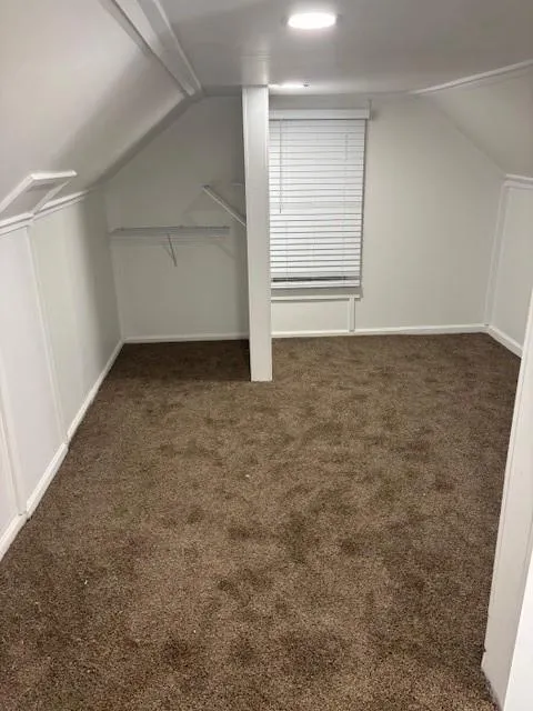 Bonus room featuring carpet flooring and lofted ceiling
