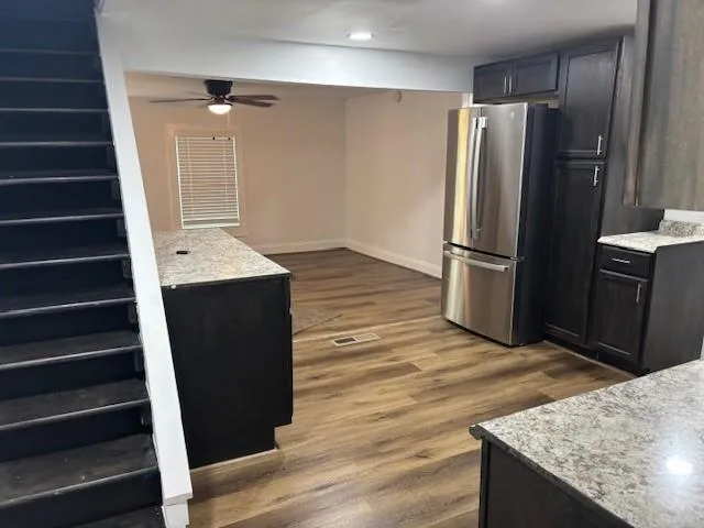 Kitchen featuring freestanding refrigerator, dark wood-style floors, ceiling fan, and recessed lighting