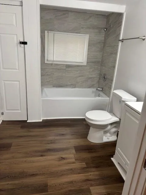 Full bath with vanity, wood finished floors, and bathtub / shower combination