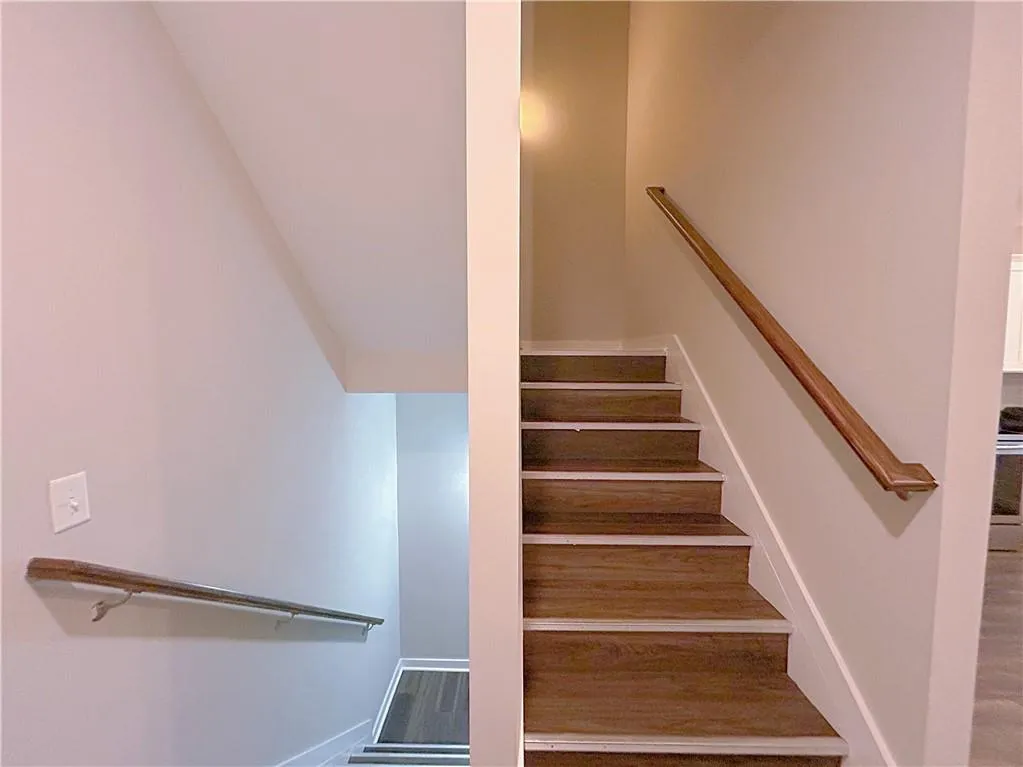 Stairway featuring wood-type flooring