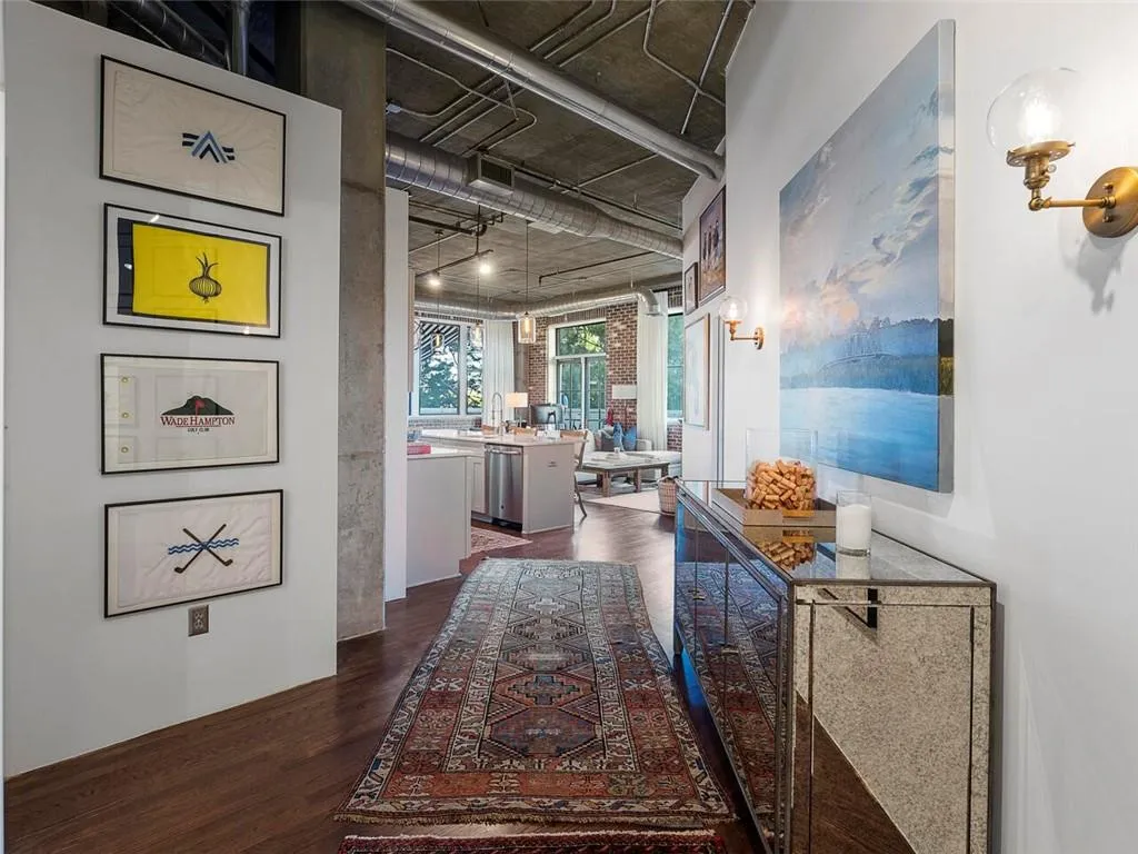 Exposed industrial-style ceiling with ductwork, concrete support pillars, and recessed lighting