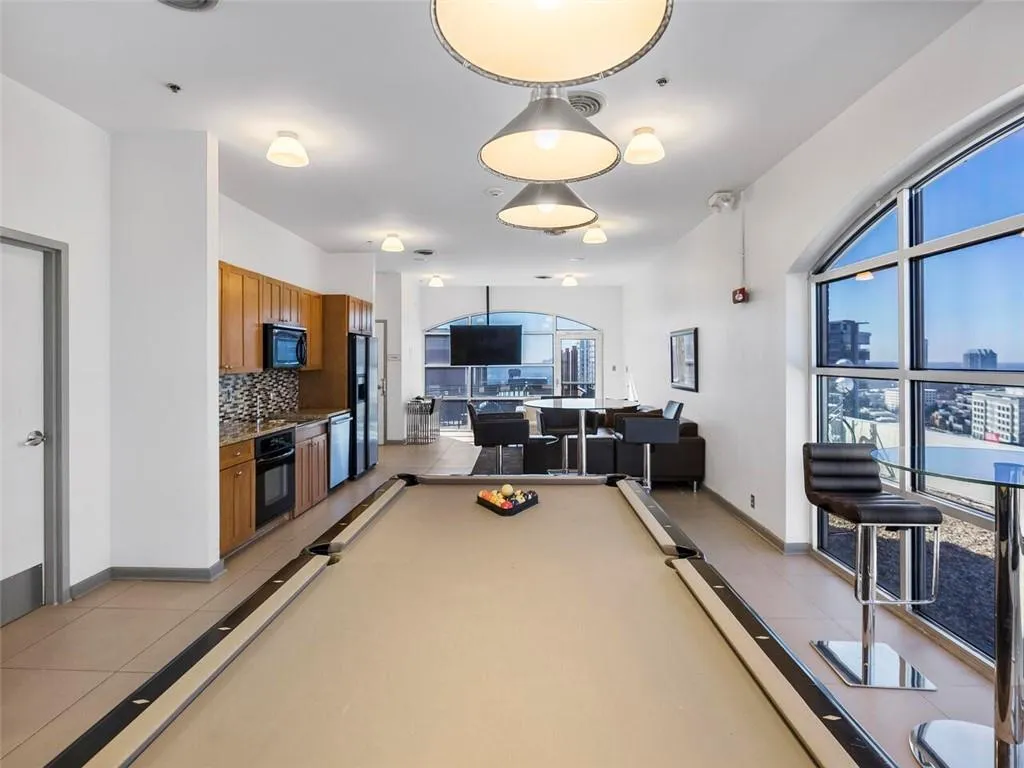 Full kitchen featuring wood cabinetry and integrated appliances