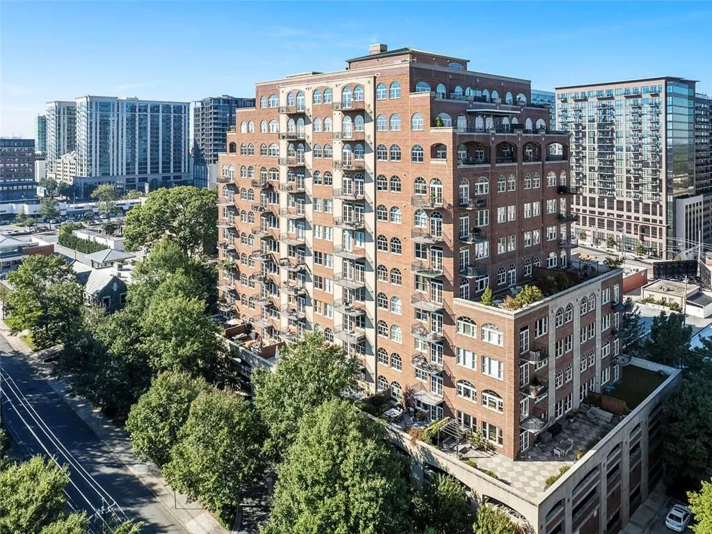 Brick exterior with arched windows, multiple private balconies, and a multi-level design