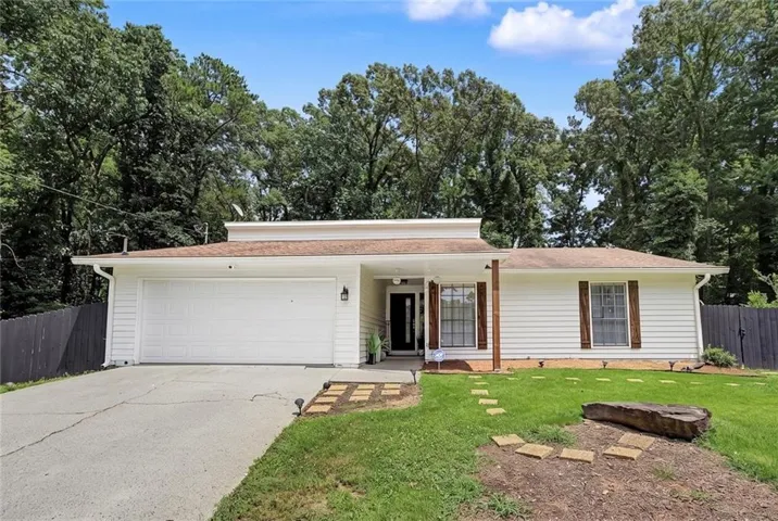 Ranch-style exterior with white siding, a two-car garage, and a covered entryway