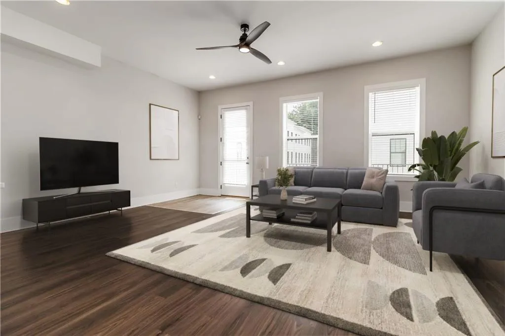 Living area featuring wood finished floors, ceiling fan, and recessed lighting