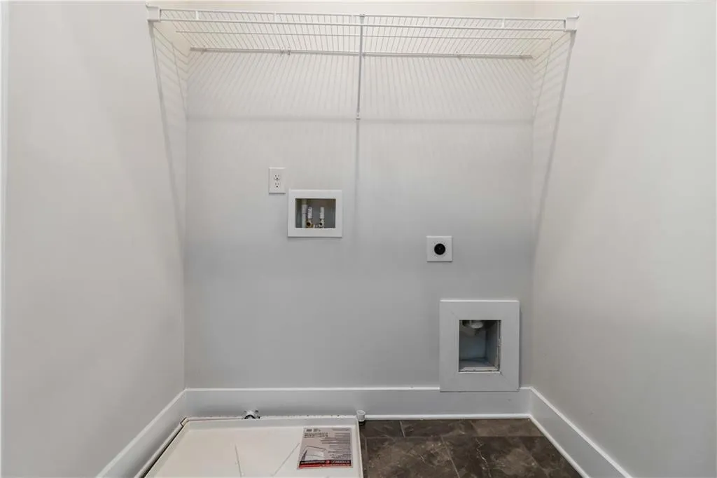 Washroom featuring hookup for a washing machine and electric dryer hookup