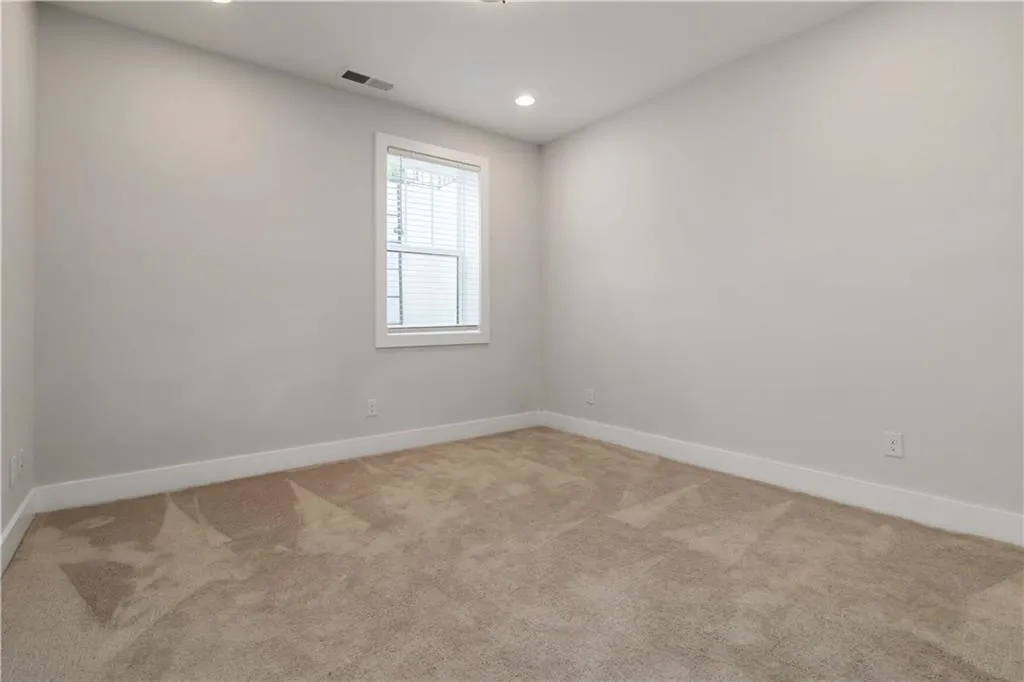 Empty room with carpet floors and recessed lighting