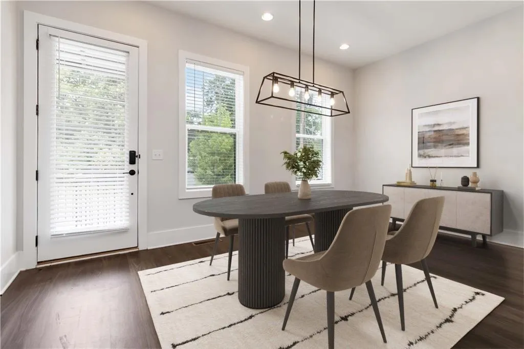 Dining room with dark wood finished floors, a chandelier, and recessed lighting