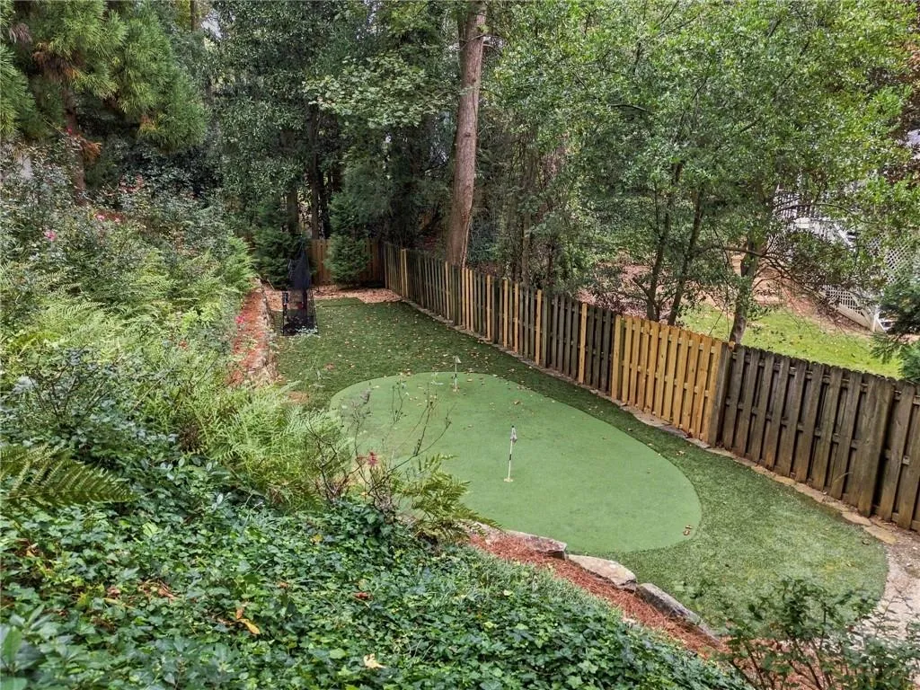 Great turf play area and putting green below pool.