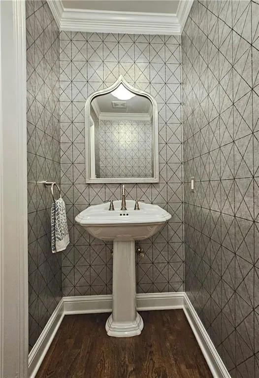 Bathroom with wood finished floors and crown molding