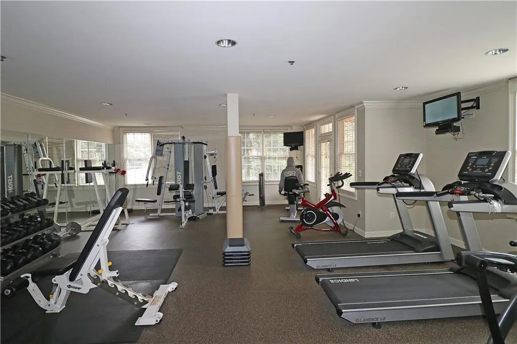 Exercise room featuring ornamental molding, plenty of natural light, and recessed lighting