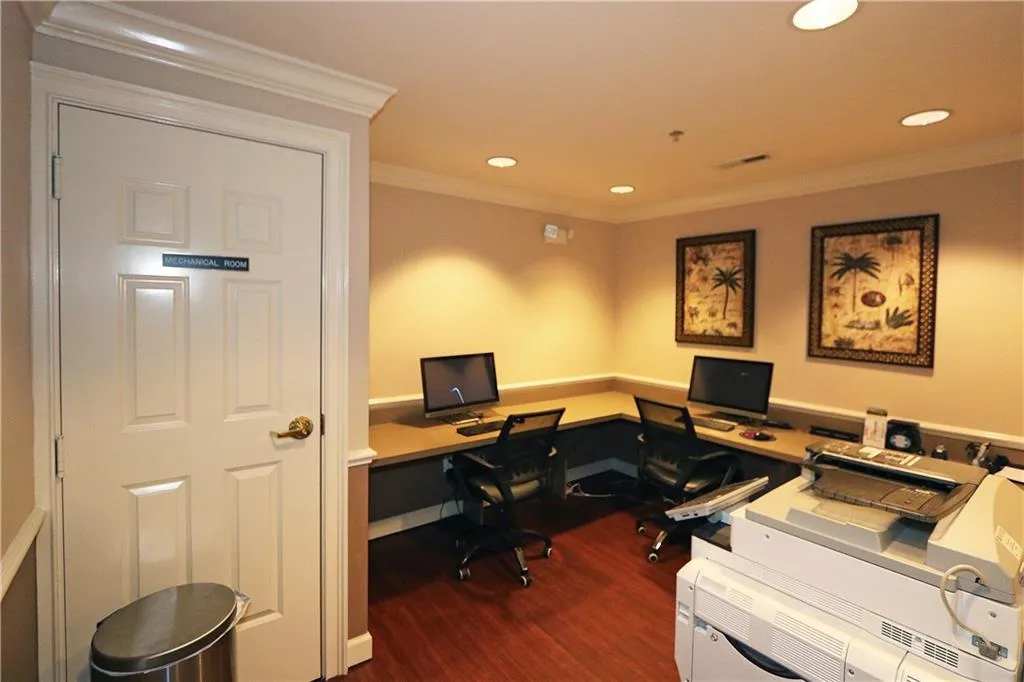 Office area with dark wood-type flooring, recessed lighting, and ornamental molding