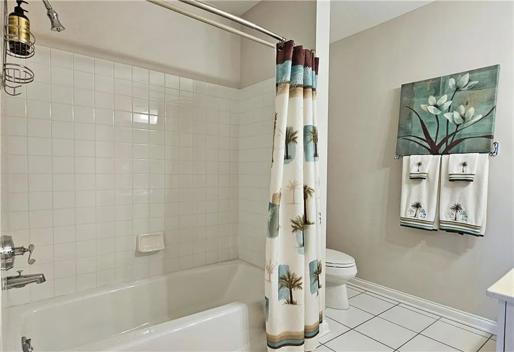 Full bath featuring tile patterned flooring, shower / tub combo, and vanity