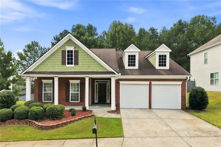 Brick and shingle exterior with a covered porch