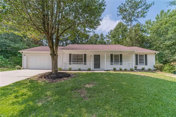 Ranch-style residence featuring white siding, dark shutters, and a covered front porch with white railing