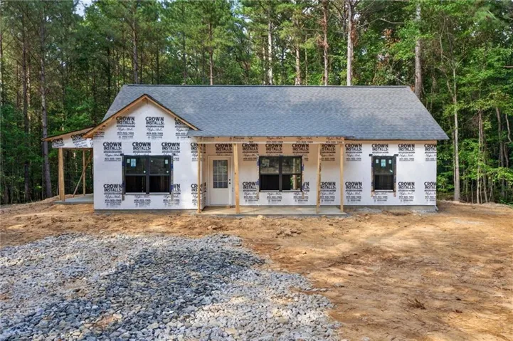 New construction residence with an attached porch, exposed porch columns, and a gray shingle roof