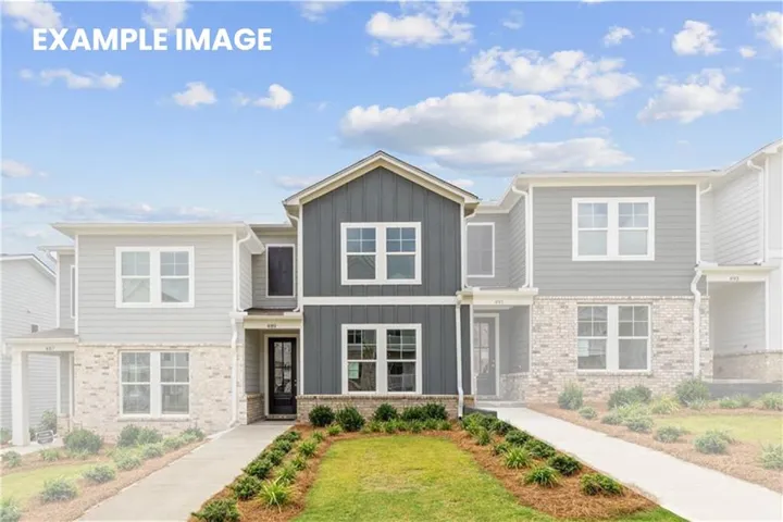 Contemporary townhome exterior featuring a prominent gabled entry, dark vertical siding, light horizontal siding, brick veneer, and white-framed windows