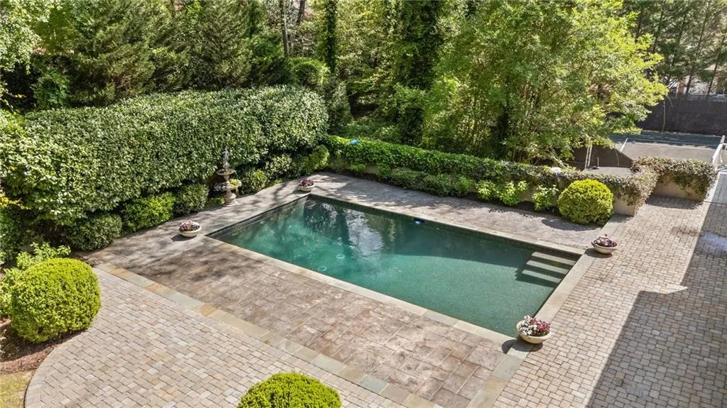 View of pool featuring a fenced backyard and patio surround