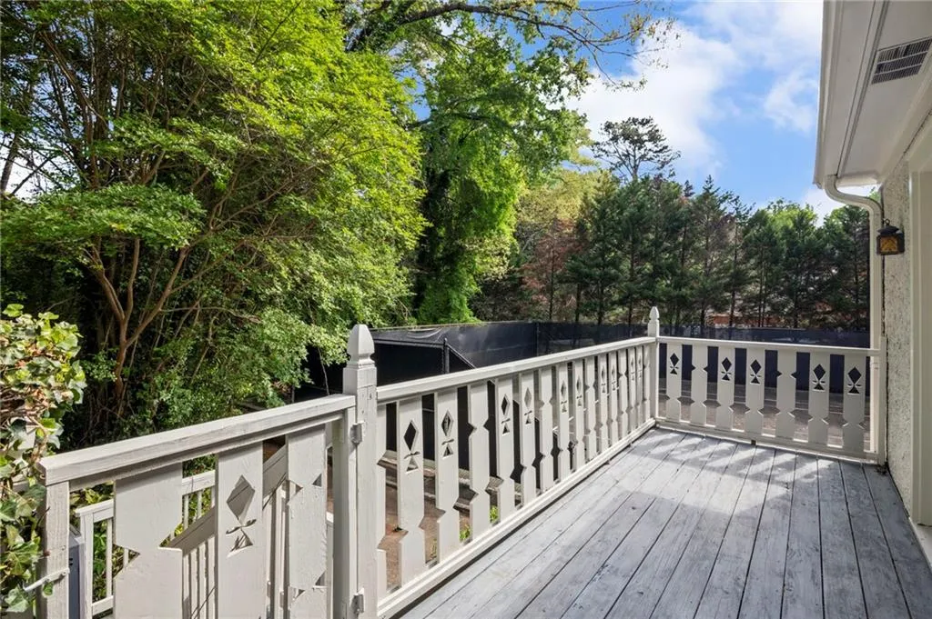 Porch off of Primary Suite overlooking tennis court and adjoining to pool area
