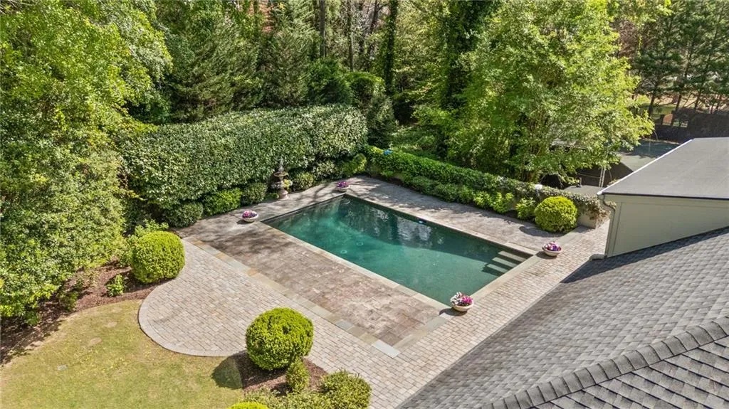 Swimming pool featuring a fenced backyard and a patio area