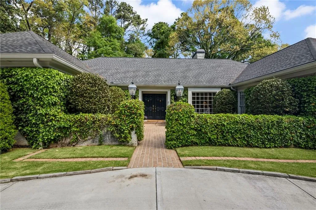 Impressive European-style front entrance with lanterns, ivy, and double doors