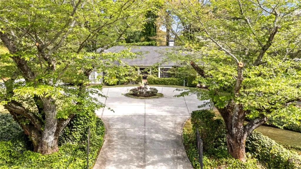 Gated entrance opens to Garden - like setting with mature and beautifully manicured landscaping