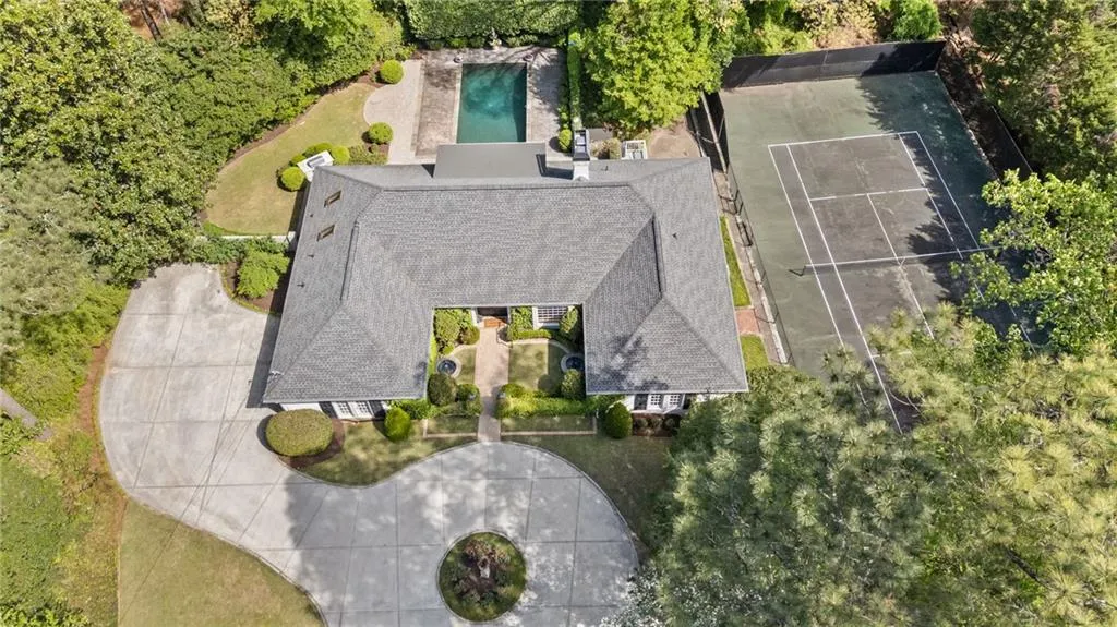 Aerial view of property and surrounding area featuring a pool area