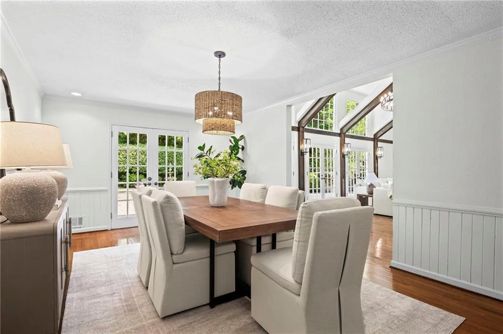 French doors in dining room open to pool area