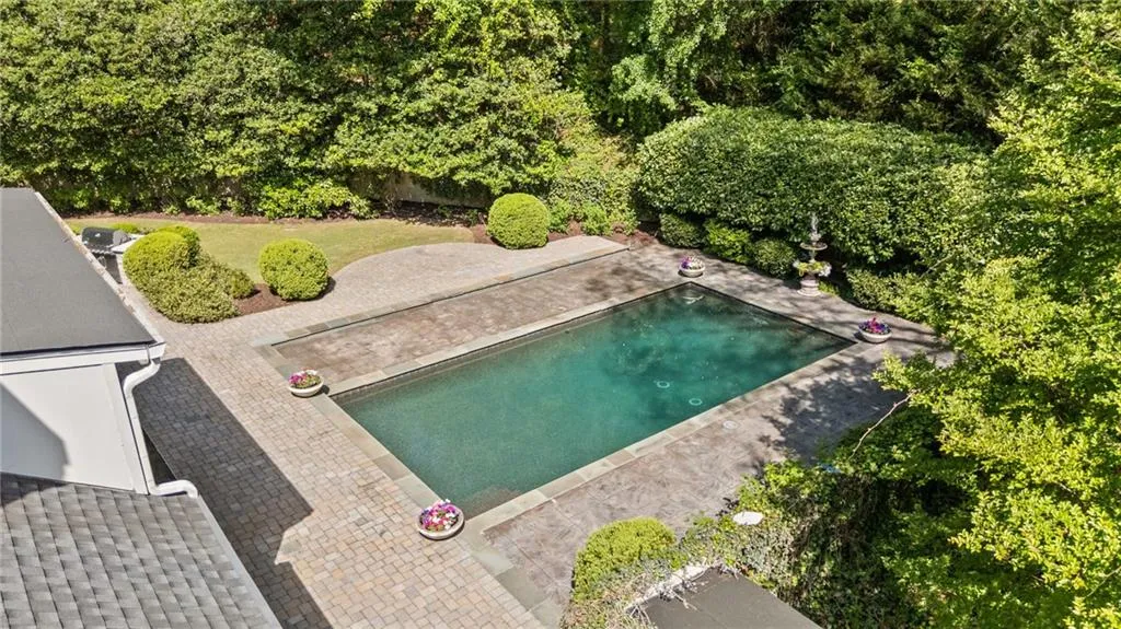 Walkout gunnite heated pool on main level of home