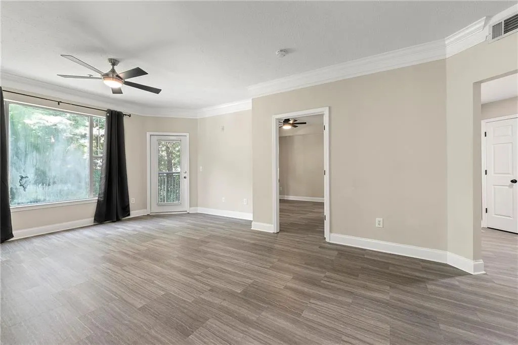 Spare room featuring ornamental molding and ceiling fan
