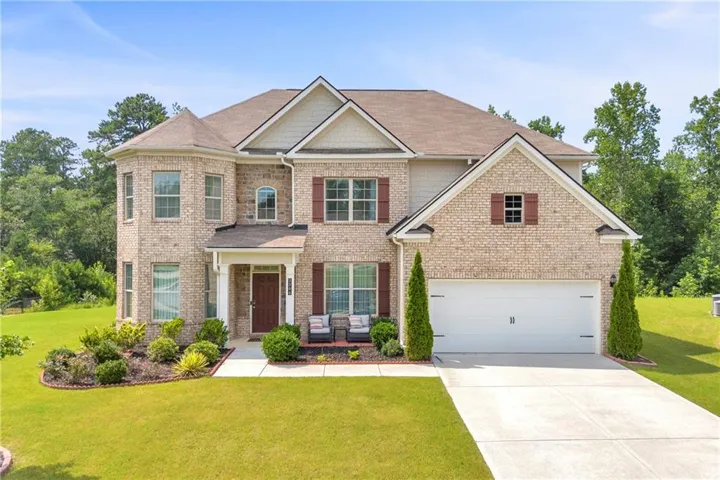 Traditional two-story residence with a brick facade and gabled rooflines