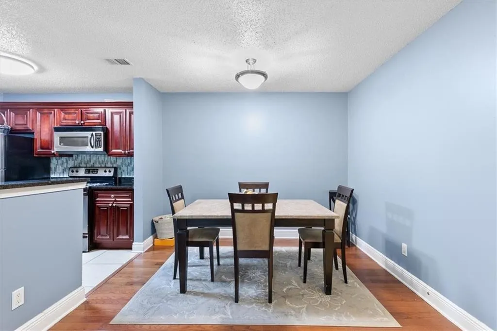Tiled dining area with a textured ceiling
