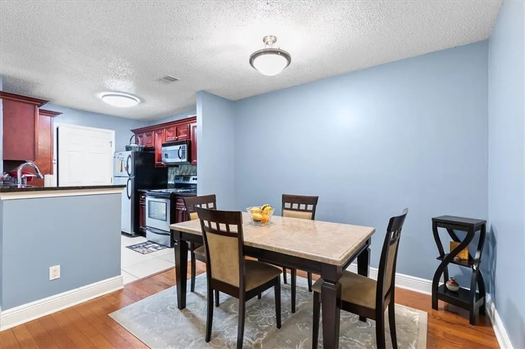Tiled dining space featuring sink and a textured ceiling