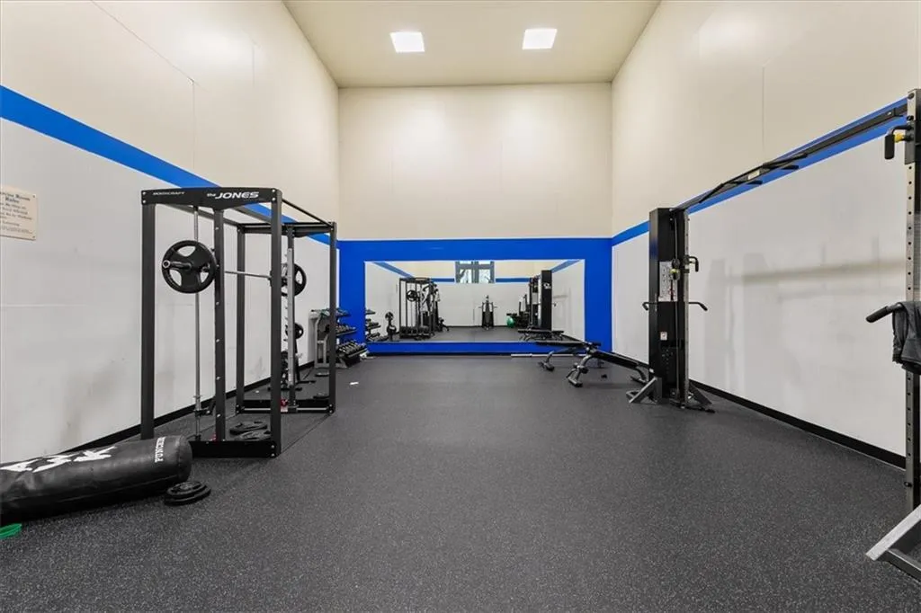 Exercise room with a towering ceiling