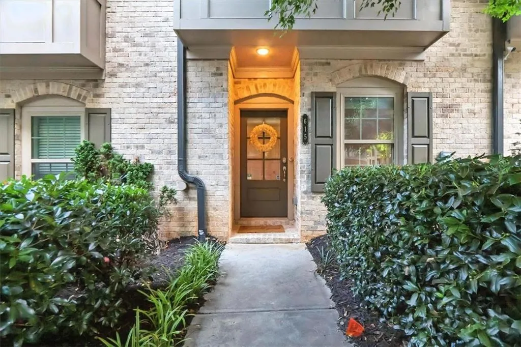 Doorway to property featuring brick siding