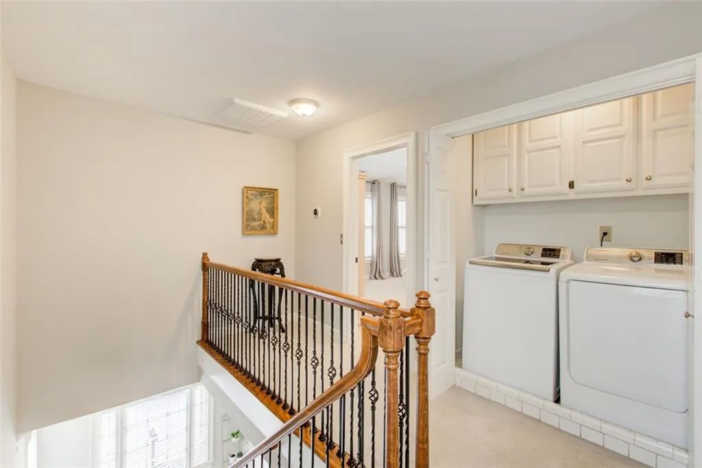 Landing at top of stairs hosts the Laundry Closet with built in cabinetry