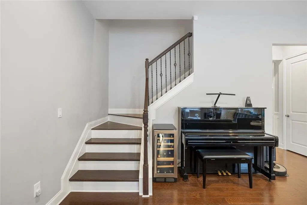 Staircase featuring hardwood flooring