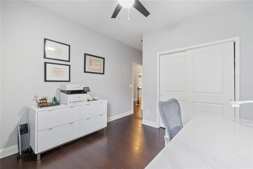 Bedroom with ceiling fan, a closet, and hardwood flooring
